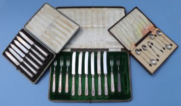 A cased set of six coffee bean spoons and sugar tongs, Birmingham 1930; a cased set of silver
