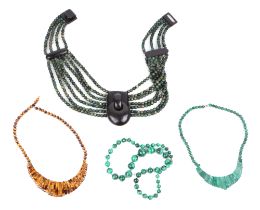 A group of tigers eye, malachite and horn bead necklaces.