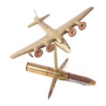 A trench art cast brass model of a Sutherland aeroplane, mounted on a artillery shell case stand,