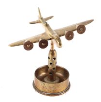 A trench art cast brass model of a Sterling aircraft, mounted on a brass shell case, wingspan 19cm.