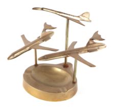 Two DC10 cast brass models, together with a brass model of Concord, mounted on a brass ashtray, 25cm