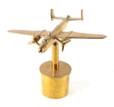 A trench art cast brass model of a Mitchell aircraft, mounted on a brass shell case, 27cm diameter.