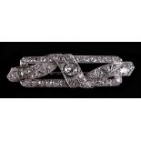 A white metal diamond set panel brooch, set with 48 diamonds, central diamond approx 4.5mm diameter,