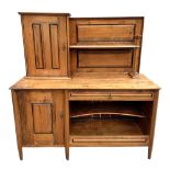 An Arts and Crafts pine dresser, having a super structure with cupboard, having a panel door