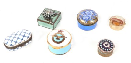 A group of ceramic and enamel pill boxes.