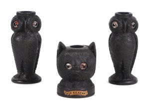 A pair of Irish carved bog oak needle / bobbin holders, in the form of owls, 8cm high, and another