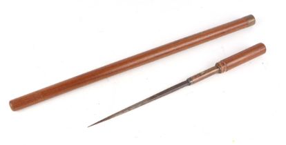 A military wooden swagger/sword stick, having a short stiletto blade, and indistinct description