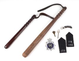 Police interest; a Metropolitan Police cap badge, shoulder titles FH 351, two hardwood truncheons