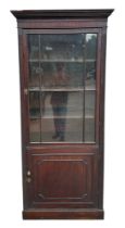A 19th century mahogany glazed book case on cupboard, having a moulded cornice above an astragal