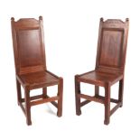 A pair of Arts and Crafts oak chapel chairs, formally from Cheltenham Ladies Collage, the back