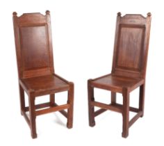 A pair of Arts and Crafts oak chapel chairs, formally from Cheltenham Ladies Collage, the back