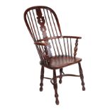 A 19th century Windsor stick back open arm chair, with pierced back splat, solid elm seat, on turned