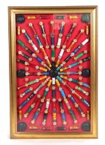 A framed display of Eley and other 12-bore shotgun cartridge cases and clays, framed and glazed,