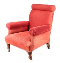 An Edwardian upholstered country house arm chair, with turned front legs.