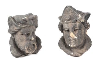 A pair of possibly 17th century carved stone corbels, in the form of a King and Queen, each approx