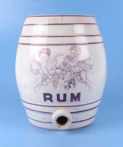 A Victorian pottery rum barrel, with puse printed Bacchanal motif , 32cm high.