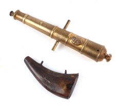 A brass signal cannon, with Royal coat of arms crest, 23long and a 19th century cow horn gun power