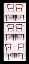 A set of six William IV mahogany balloon back dining chairs, with over stuffed seats and baluster