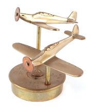 A pair of trench art cast brass models of Hurricane fighter plane aircrafts, mounted on a brass