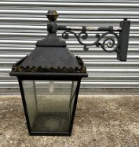 A Victorian style cast aluminium pub lantern, mounted on a wall bracket, approx 80cm high.