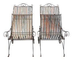 A pair of folding metal garden loungers (2).