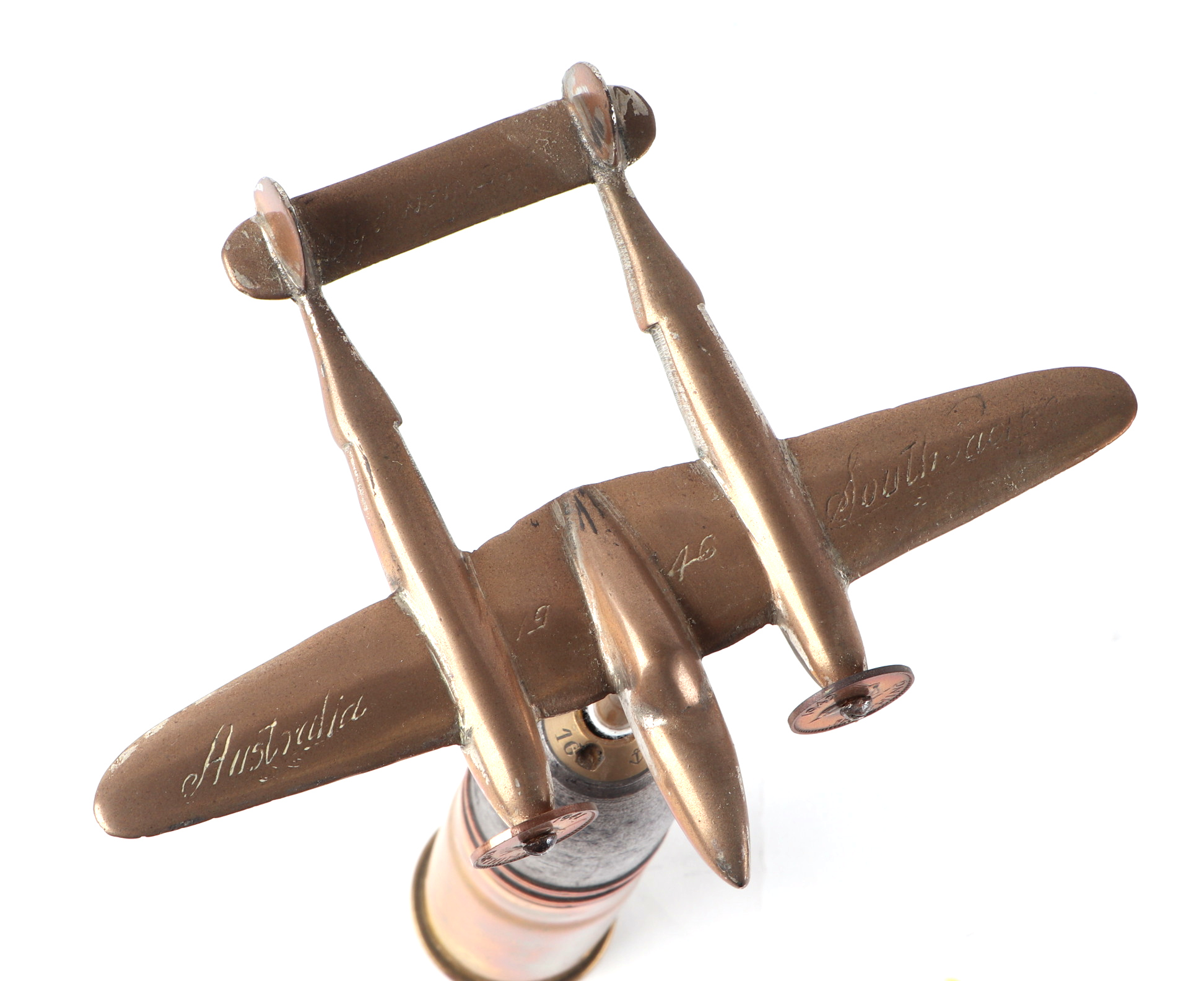 A trench art cast brass model of a Lockheed P-38 Lighting, mounted on a shell case, wingspan 16cm. - Image 2 of 2
