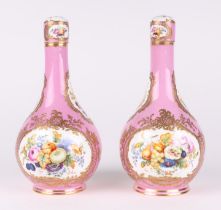 A pair of 19th century Sevres bottle vases and stoppers decorated with sprays of flowers within gilt