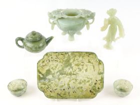 A Chinese green figured hardstone tea pot, and two tea bowls, on a matching tray, together with a