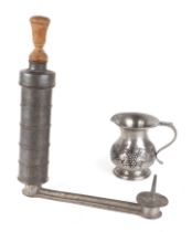An antique French pewter enema pump, 36cm high together with a pewter jug (2).