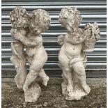A pair of 19th century composition Coade style stone putti, in well weathered condition, each approx