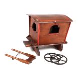 A Folk art miniature gypsy caravan (a/f), 40cm long, together with a green painted dolls cot (2).