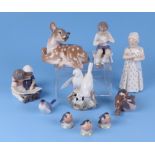 A group of Royal Copenhagen figures, to include a young girl holding a doll, robins, doves, and a