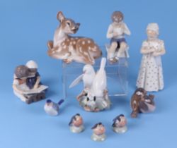 A group of Royal Copenhagen figures, to include a young girl holding a doll, robins, doves, and a