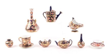 A group of Royal Crown Derby Imari pattern miniatures, to include tea pot, sugar bowl, watering can,