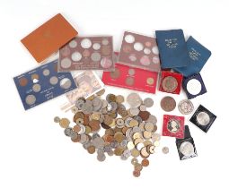 A quantity of mixed UK and foreign coinage to include proof sets.
