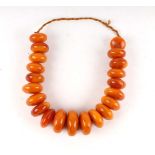 A graduated Butterscotch copal/amber type bead necklace, largest bead 5.5cm diameter, total weight