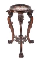 A Chinese carved hardwood jardinière stand, having a circular inset marble top, on carved cabriole