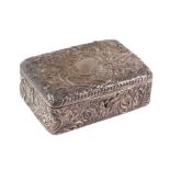 A late Victorian silver jewellery box, profusely embossed with folate scrolls and having a blank