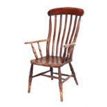 A 19th century Windsor open arm chair, having a solid elm seat, turned front legs, joined by a H