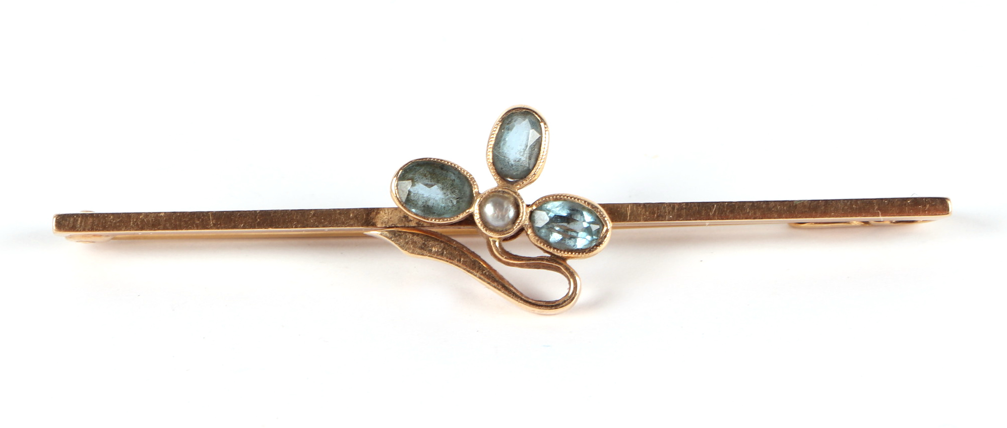 An Edwardian yellow metal bar brooch, set with three aquamarine and a single seed pearl, 5.5cm wide, - Image 2 of 3
