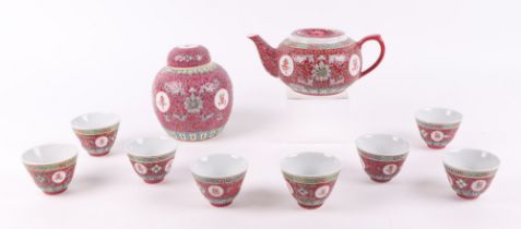 A Chinese famille rose teapot and cover, decorated with panels of calligraphy, 10cm high, a