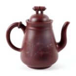 A Chinese Yixing pottery teapot decorated with bamboo, four character mark to the underside, 16cm