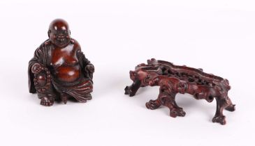A carved bamboo figure of a seated Buddha, holding a bead necklace and a sack, 9 cm high, together