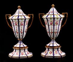 A pair of Minton's two handled pedestal vases and covers, decorated garlands of roses. Condition