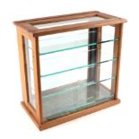 An oak framed table top glass display cabinet, with four internal glass shelves, 39cm wide.