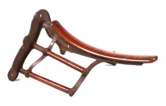 A late 19th century Musgrave of Belfast & London cast iron and mahogany wall mounted saddle rack,