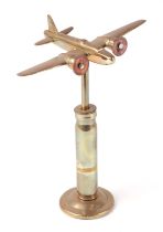 A trench art cast brass model of a Wellington bomber, mounted on a brass plinth, wingspan 17cm.