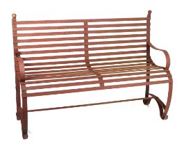 A iron strap work garden bench, with scroll arms and feet, and ball finials, 140cm high.