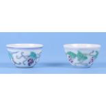 A pair of Chinese Wucai style tea bowls, decorated with grapes and vines, with 6 character blue mark