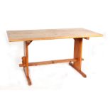 A modern pine refectory style table, having rectangular top, on style supports, joined by a